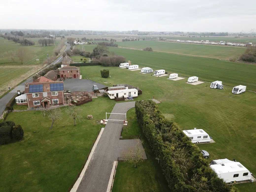 house-building-800x400 Aerial view of a countryside caravan park with farm buildings and open fields
