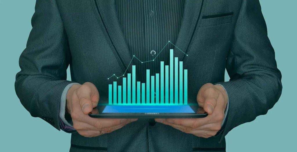 Businessman holding a tablet with a glowing digital bar graph and data line