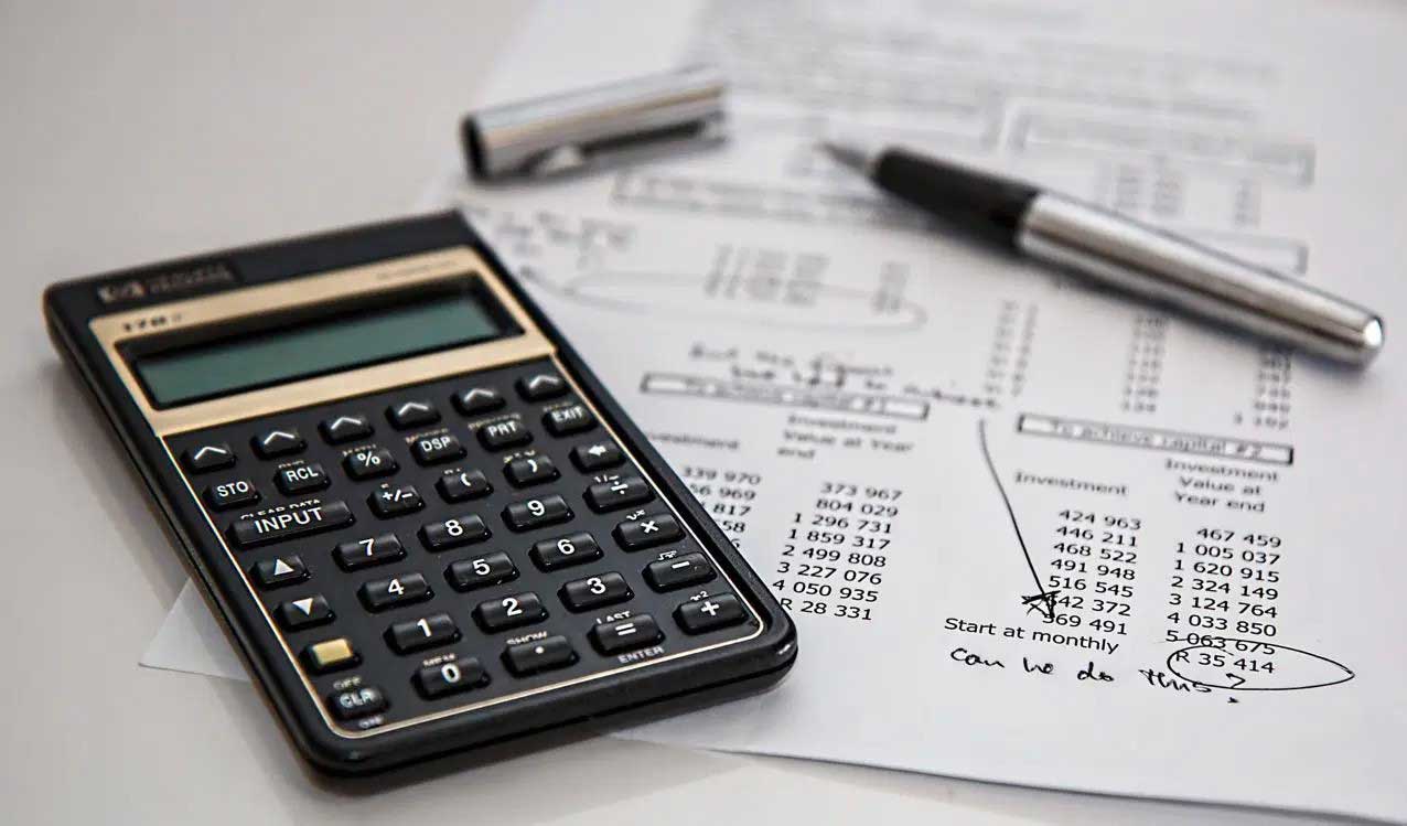 house-building-800x400 Black calculator and silver pen resting on financial documents with handwritten notes